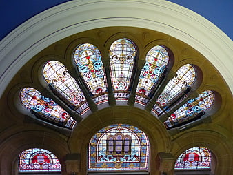 Ornate Stained Glass Windows in Arched Stone Architecture