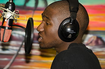 Male Rapper Recording In Studio With Professional Microphone