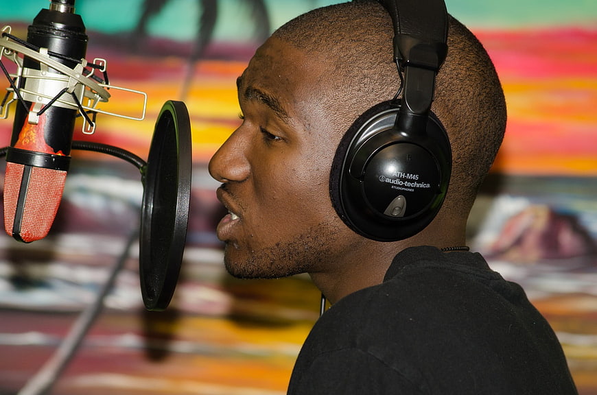 Male Rapper Recording In Studio With Professional Microphone