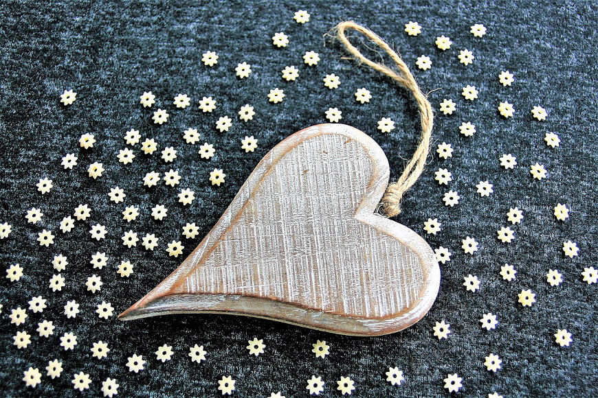 Wooden Heart Ornament with Star-Shaped Pasta on Dark Fabric