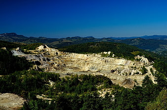 Aerial View Of Abandoned Open-Pit Mine In Mountainous Landscape