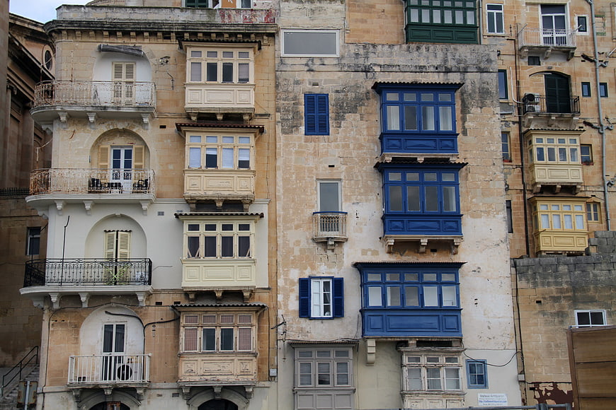 Traditional Maltese balconies on historic stone building facade