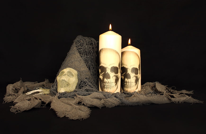 Halloween Skull Candles and Cobwebs on Black Background