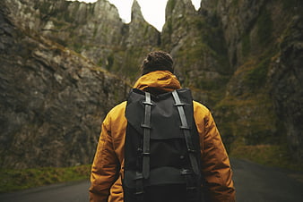 Hiker with Backpack on Mountain Road