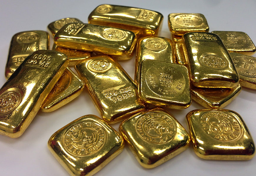 Pile of Gold Bullion Bars on White Background