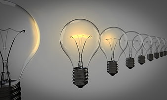 Row of glowing light bulbs symbolizing ideas and innovation