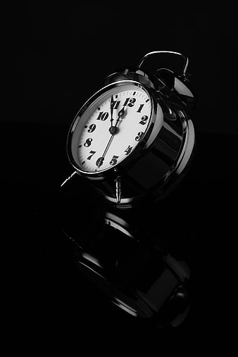 Vintage Black and White Alarm Clock on Black Background