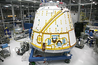 Space capsule assembly in high-tech aerospace manufacturing facility