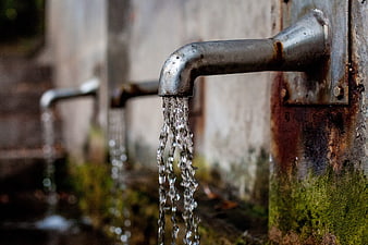 Close-up of Rusty Metal Faucet Flowing Water