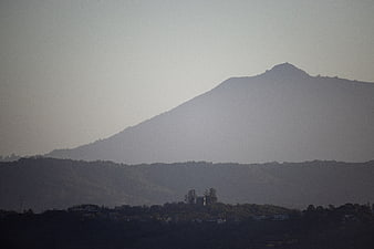 Silhouette of mountain peak through atmospheric fog and haze