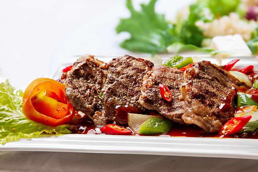 Grilled Beef Steak with Peppers and Tomatoes on White Plate