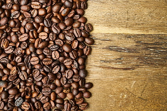 Roasted coffee beans on rustic wooden background with copyspace