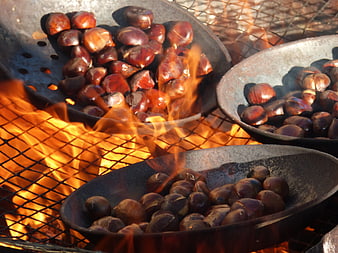 Roasted Chestnuts In Metal Bowls Over Open Fire