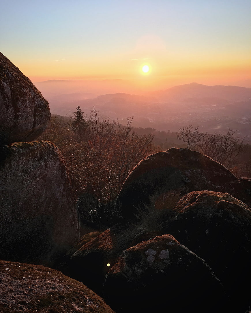 Sunset Over Rocky Mountain Landscape With Misty Valley