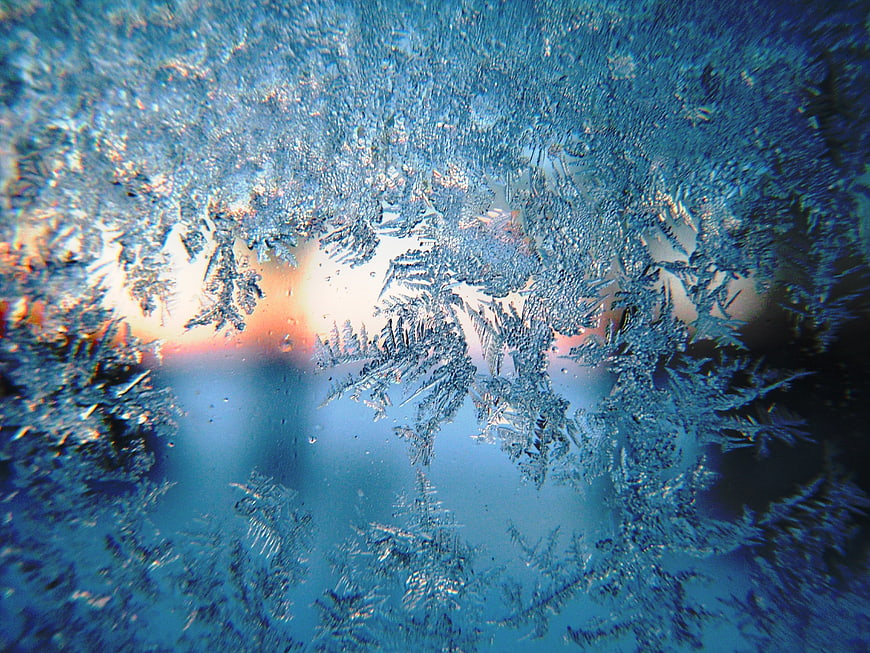 Macro Frost Patterns On Glass With Blue Tint And Light