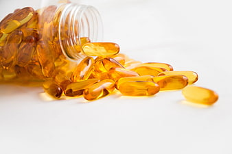 Spilled Bottle of Golden Omega 3 Fish Oil Capsules