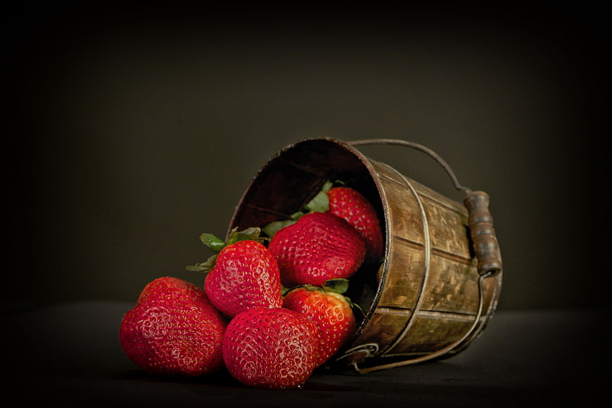 Fresh Strawberries Spilling from Vintage Wooden Bucket