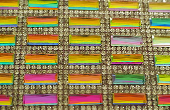 Close-up of colorful rectangular rhinestones on a bed of clear crystals