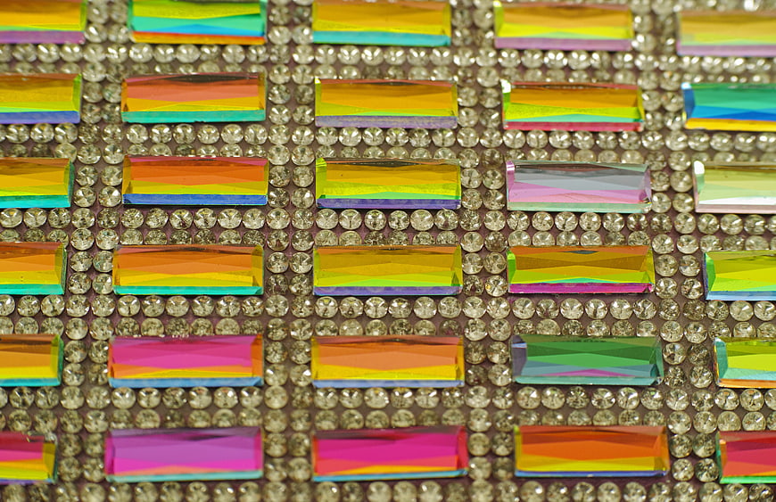 Close-up of colorful rectangular rhinestones on a bed of clear crystals
