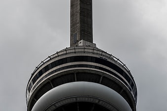 Low angle view of CN Tower against overcast sky