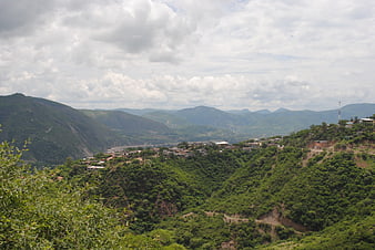Lush green mountain landscape with village in Tlapa de Comonfort