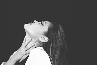 Black and white portrait of woman touching neck