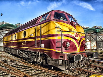 Maroon and yellow GL Cargo locomotive on railway tracks