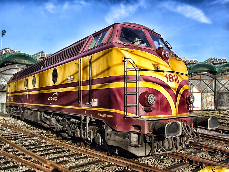 Maroon and yellow GL Cargo locomotive on railway tracks