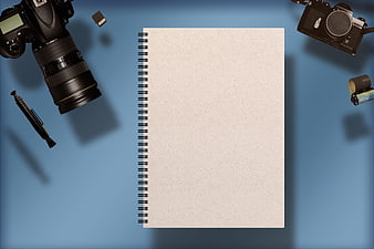 Photography Flat Lay With Cameras, Notebook, And SD Card On Blue Background