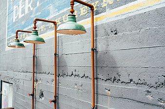 Industrial Pipe Lighting Fixtures on Textured Gray Wall