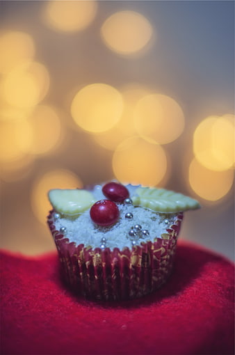 Festive Christmas Cupcake with Holiday Decorations and Bokeh Lights