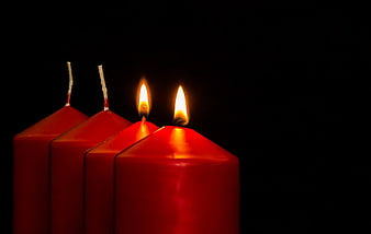 Two Lit Red Advent Candles on Black Background
