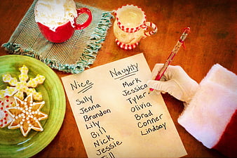 Santa Claus Writing Naughty and Nice List with Cookies