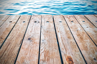 Wooden Dock Planks by Blue Swimming Pool Water