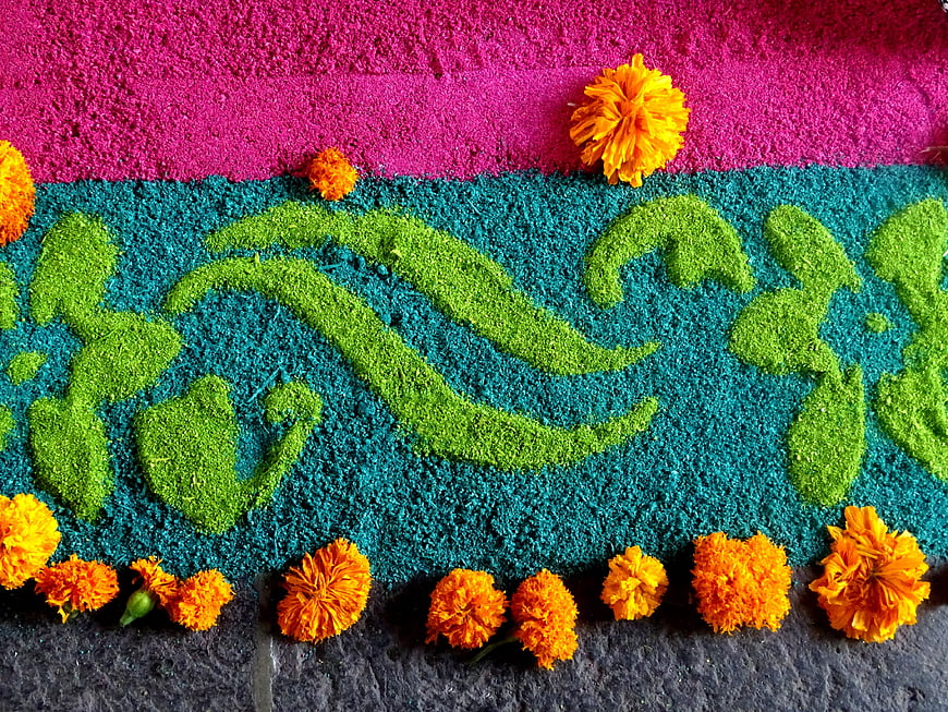 Colorful sawdust carpet with marigold flowers for Mexican festival