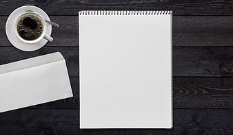Flat lay of blank notepad, coffee cup, and envelope on dark wood