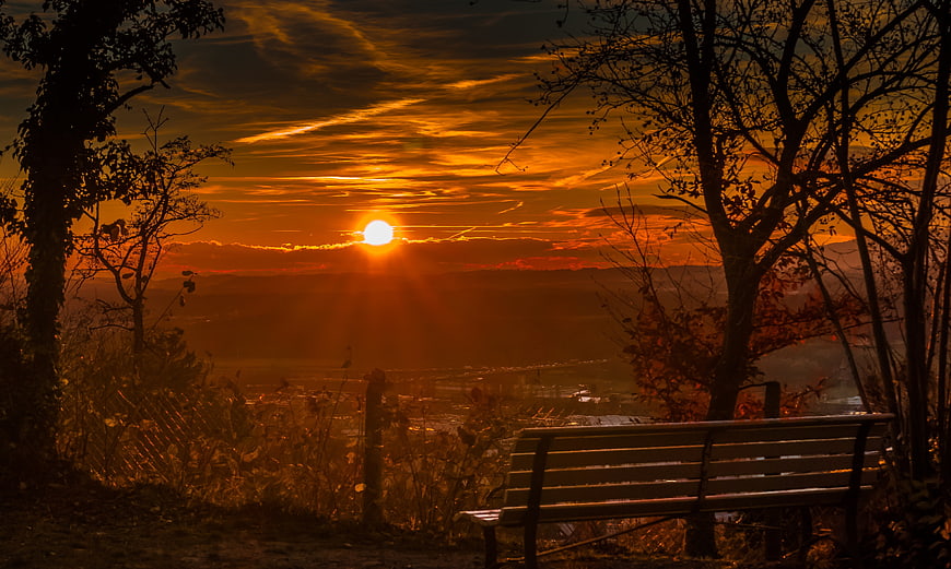 Golden Sunset Over Valley With Park Bench Silhouette