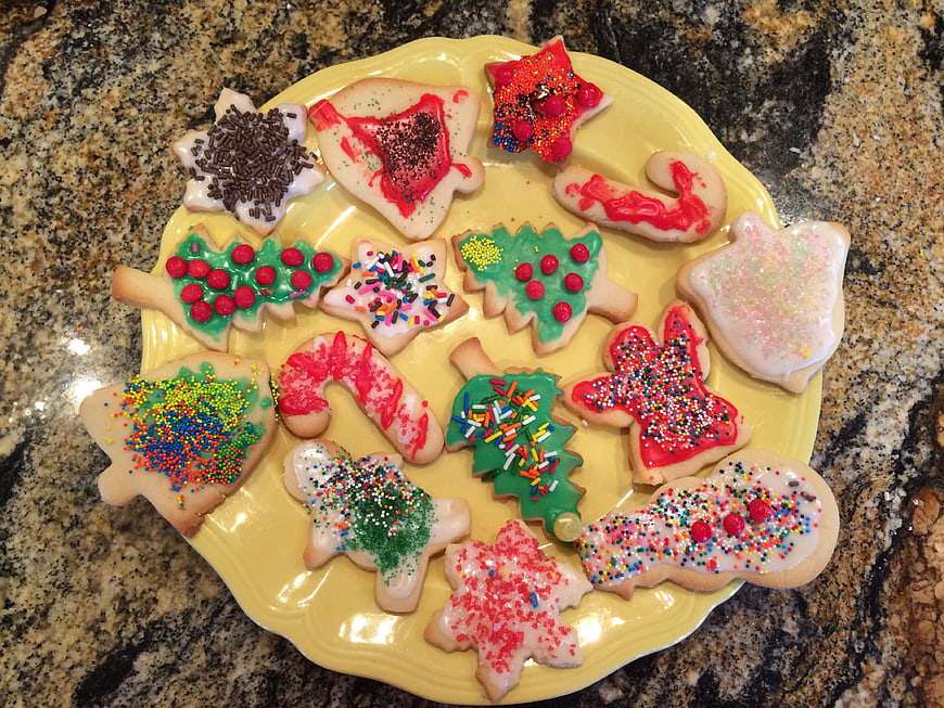 Festive Christmas Sugar Cookies With Sprinkles On Yellow Plate