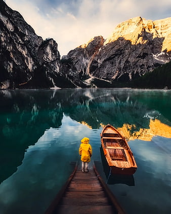 Child in Yellow Raincoat on Dock by Mountain Lake