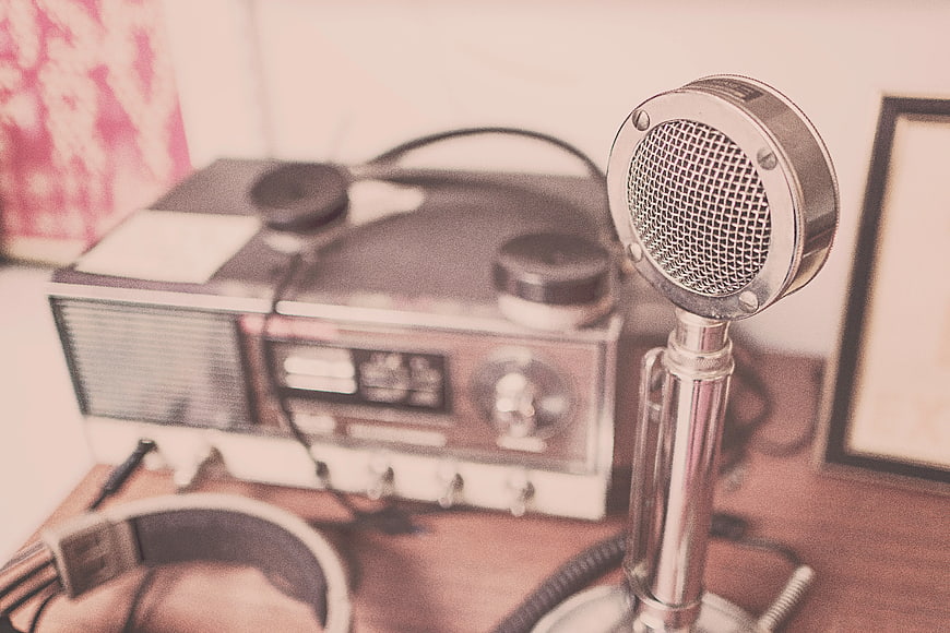 Vintage Microphone and Retro Radio on Wooden Desk