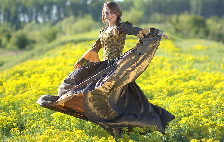 Woman in Medieval Dress Dancing in Yellow Flower Field