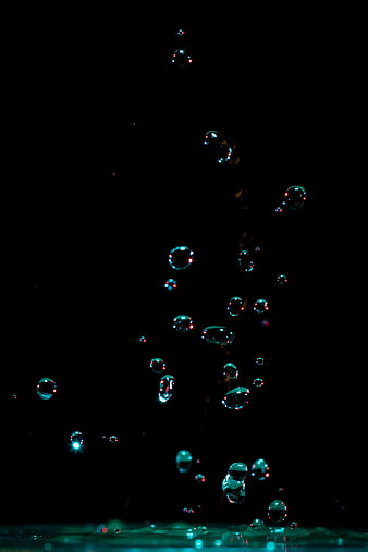 Colorful Soap Bubbles Floating Against Black Background
