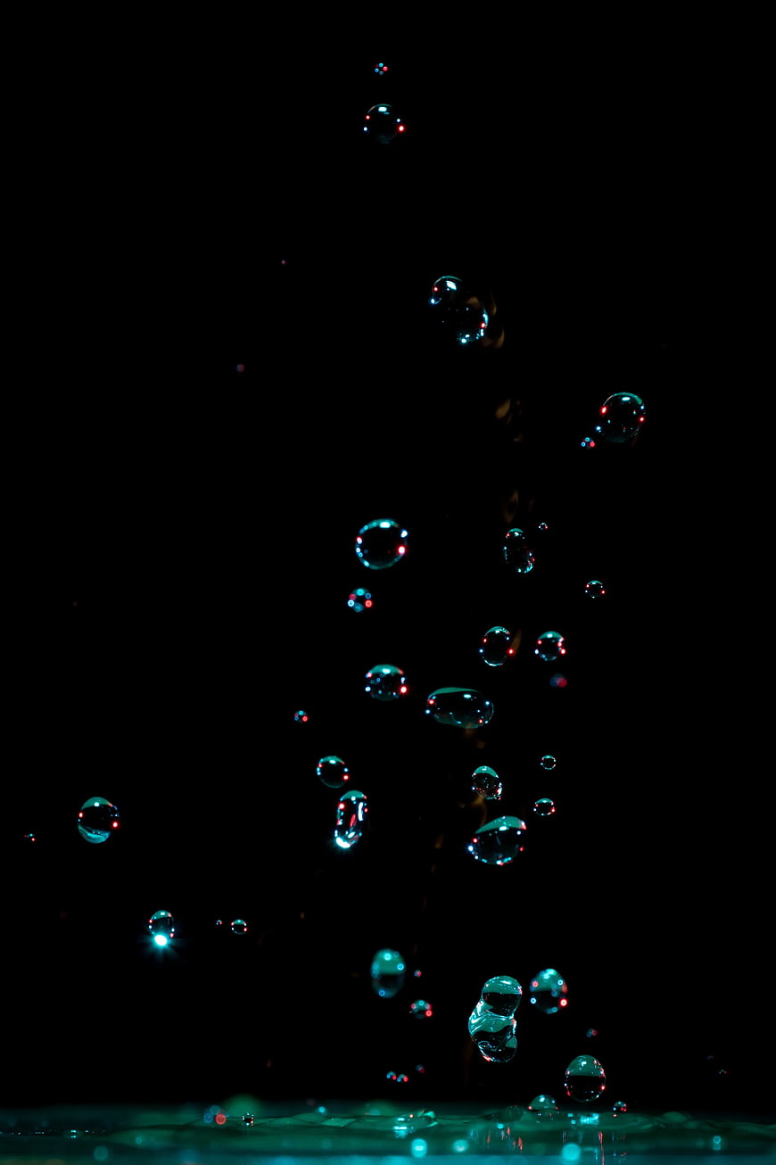 Colorful Soap Bubbles Floating Against Black Background