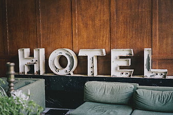 Vintage White Hotel Sign on Wooden Wall Interior