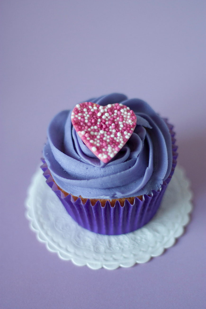 Purple Cupcake with Pink Heart Sprinkles on White Doily