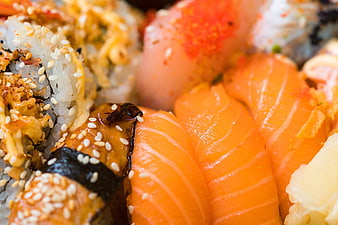 Close-Up of Fresh Salmon Nigiri and Sesame Topped Sushi Rolls