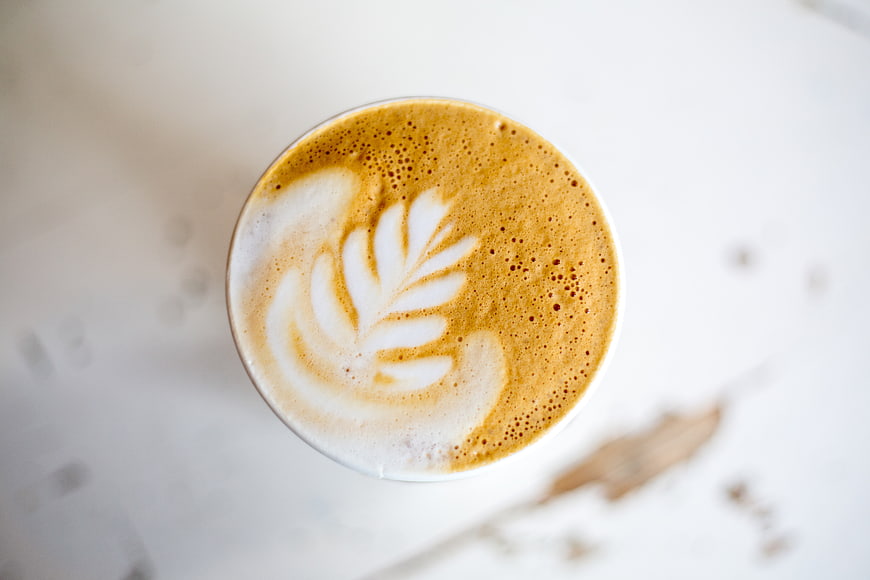 Top View of Cappuccino with Latte Art on White Table