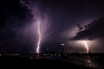 Dramatic Lightning Storm Over Harbor at Night