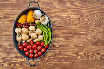 Fresh Vegetables in Black Pan on Wooden Table
