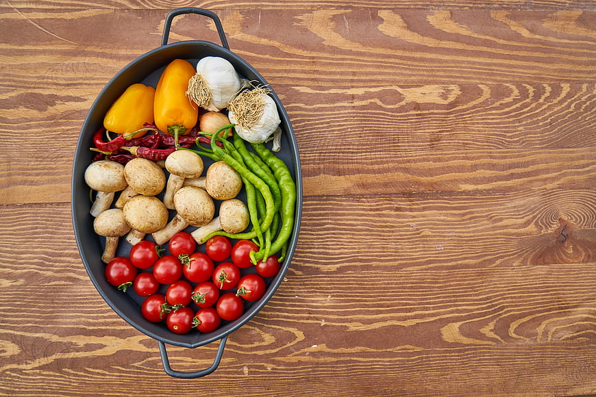 Fresh Vegetables in Black Pan on Wooden Table
